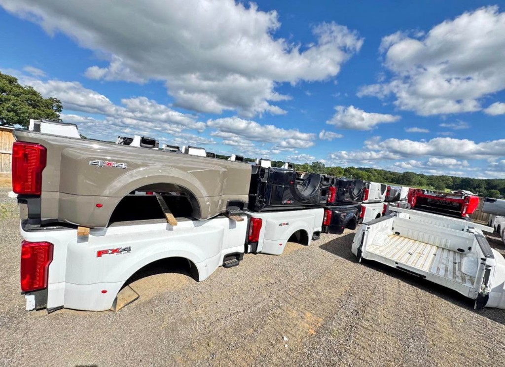 Dual-rear-wheel pickup beds stacked in an inventory yard