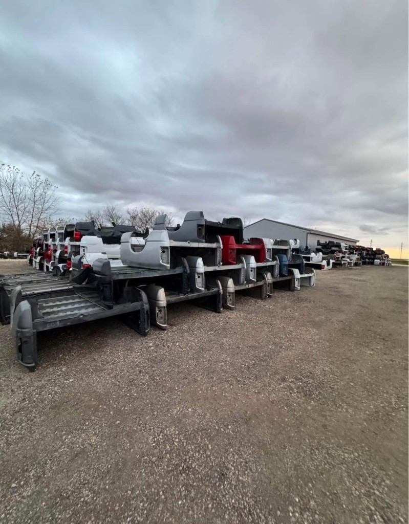 American Truck Beds outdoor inventory yard with rows of truck beds