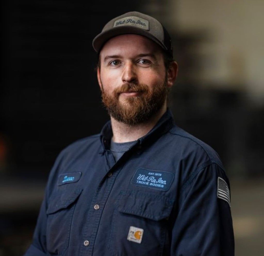 Josh JJ, owner of American Truck Beds, wearing a navy work shirt