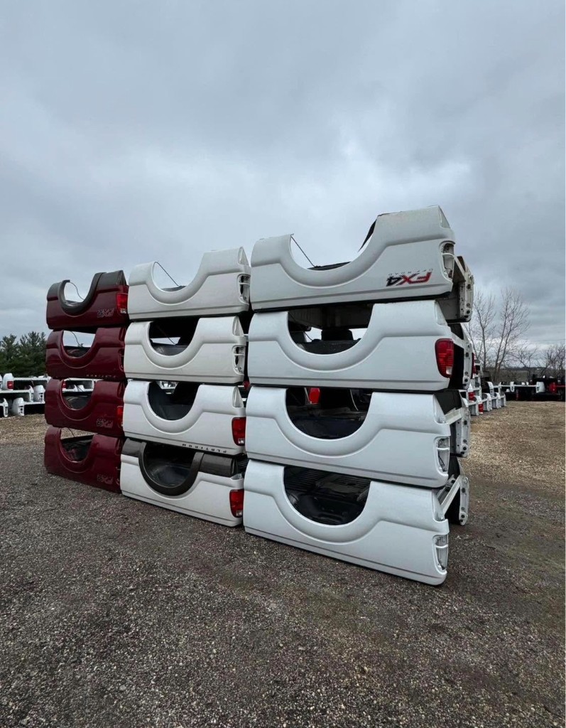 Ford FX4 pickup beds stacked in white and red
