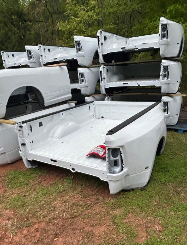 White pickup bed shells arranged outdoors